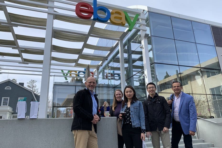 The five faculty members in front of the eBay sign