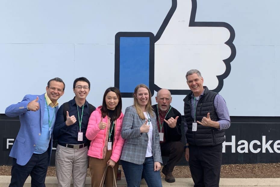 The CIC team in front of the Facebook sign