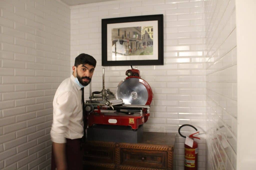 Hamdi Casanova in front of meat slicer