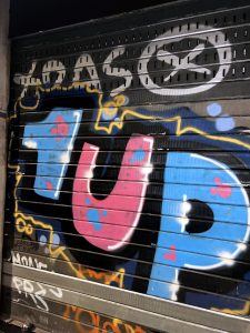 vibrant colored grafitti on garage door in Rome, Italy