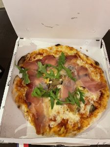Prosciutto Pizza topped with Arugula from Pepys