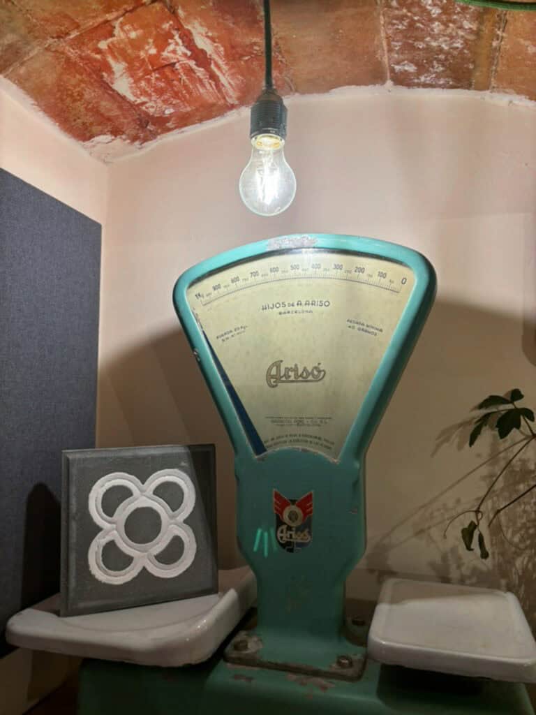 Vintage machine next to a stone slab printed with the Barcelona flower design