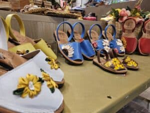 A photo of handmade espadrilles lined up on a shelf.