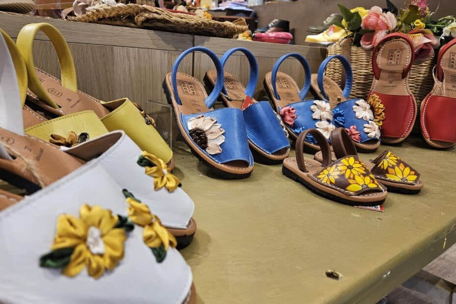 A photo of handmade espadrilles lined up on a shelf.