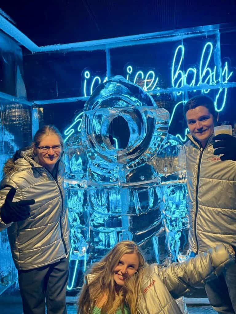 Students posing with astronaut ice sculpture.