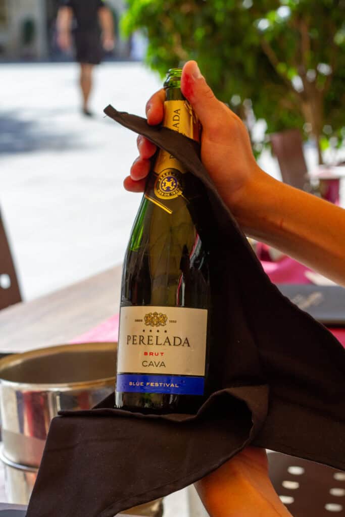 Bottle of cava being held.