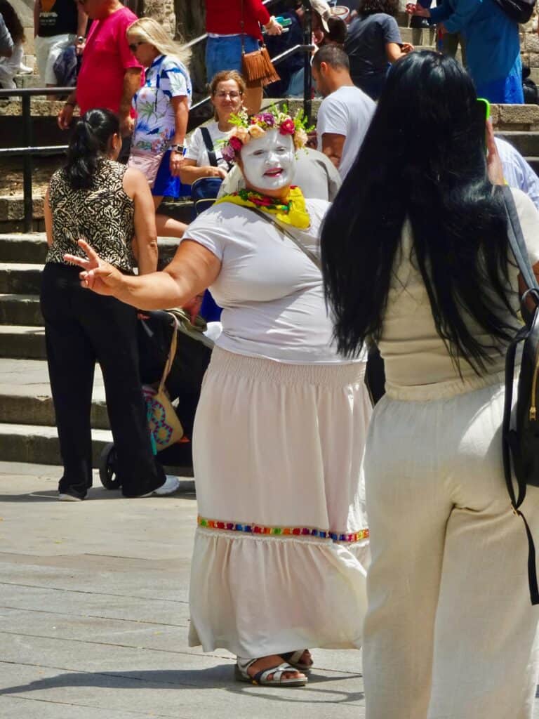 Cathedral Clown throws up a "peace sign" at camera.