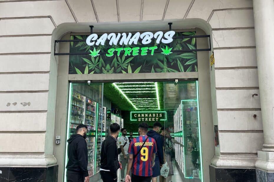 A photo of the front of a store named "Cannabis Street" with customers entering.