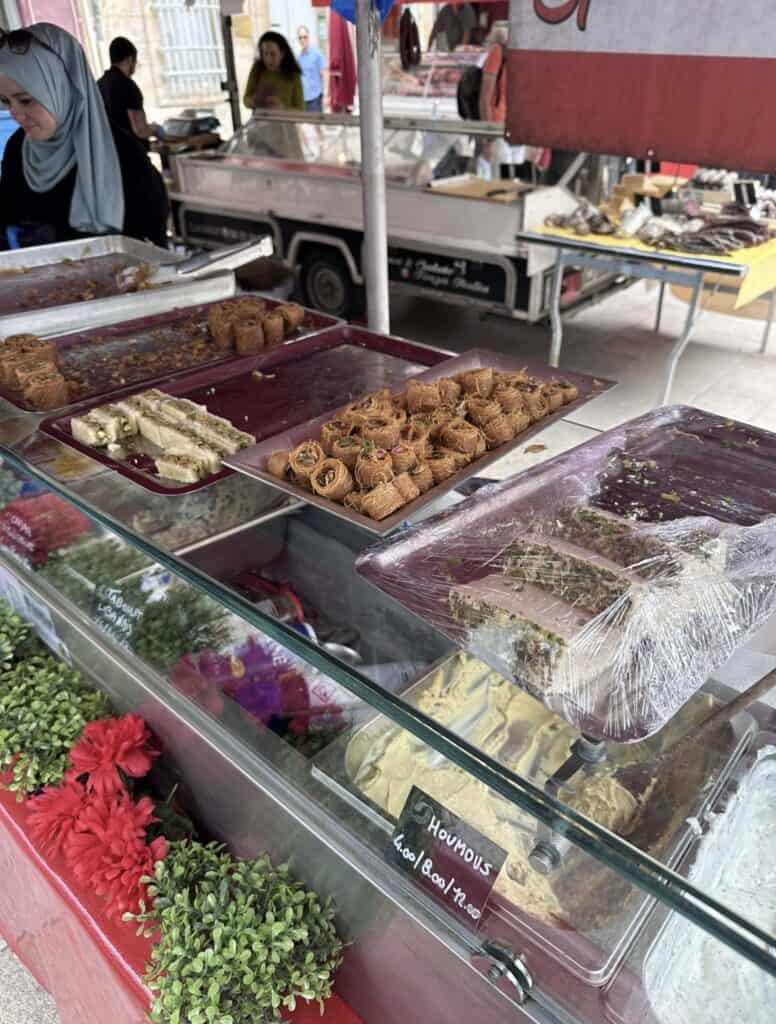 A display of food, including fresh vegetables and baked goods