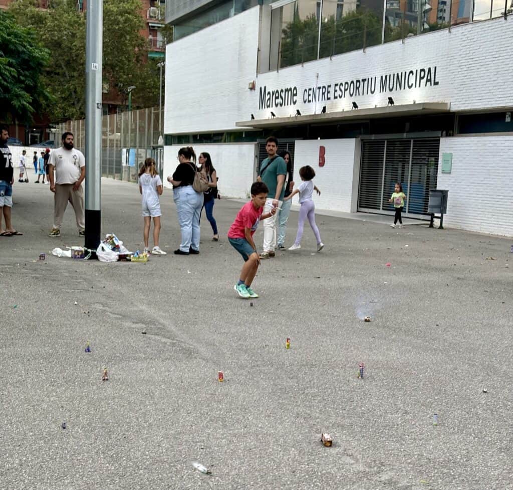 Families lighting fireworks on the sidewalks.