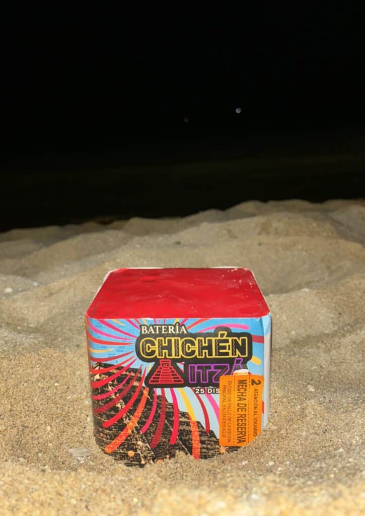 Pre-lit firework on the beach.