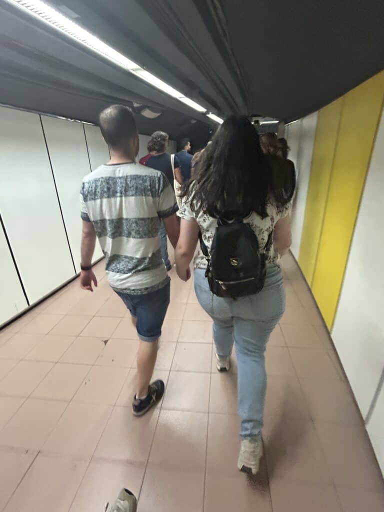 Couple holding hands in the metro.