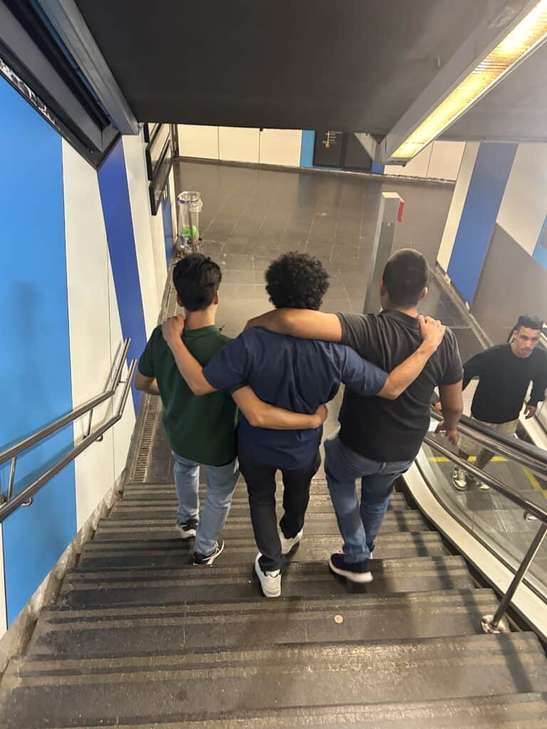3 men in an embrace