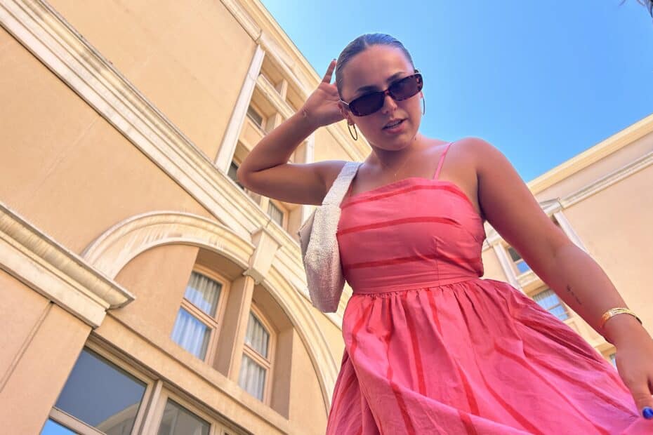 girl in pink dress wearing sunglasses and gold jewelry