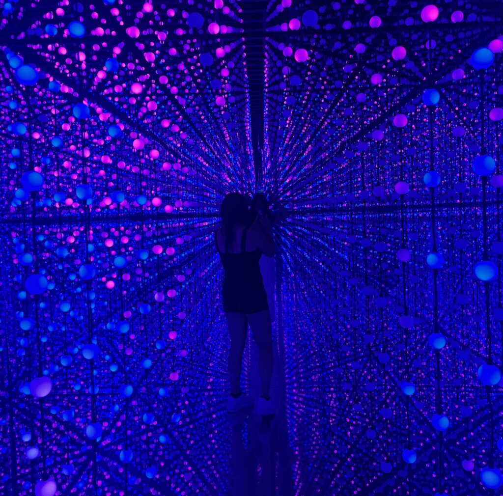 girl walking through strobe light maze at bubble planet.