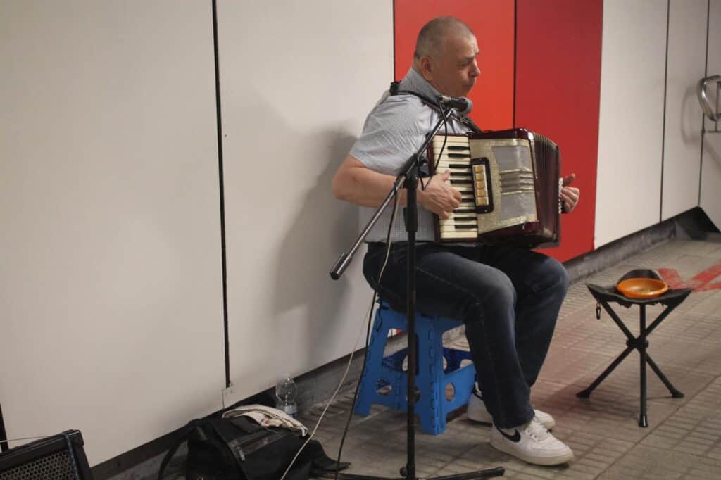 Musician playing accordion in the metro