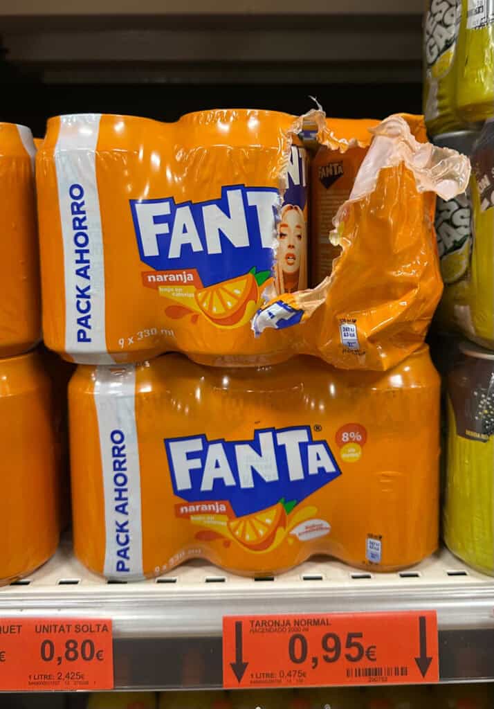 a six pack of fanta thats been opened