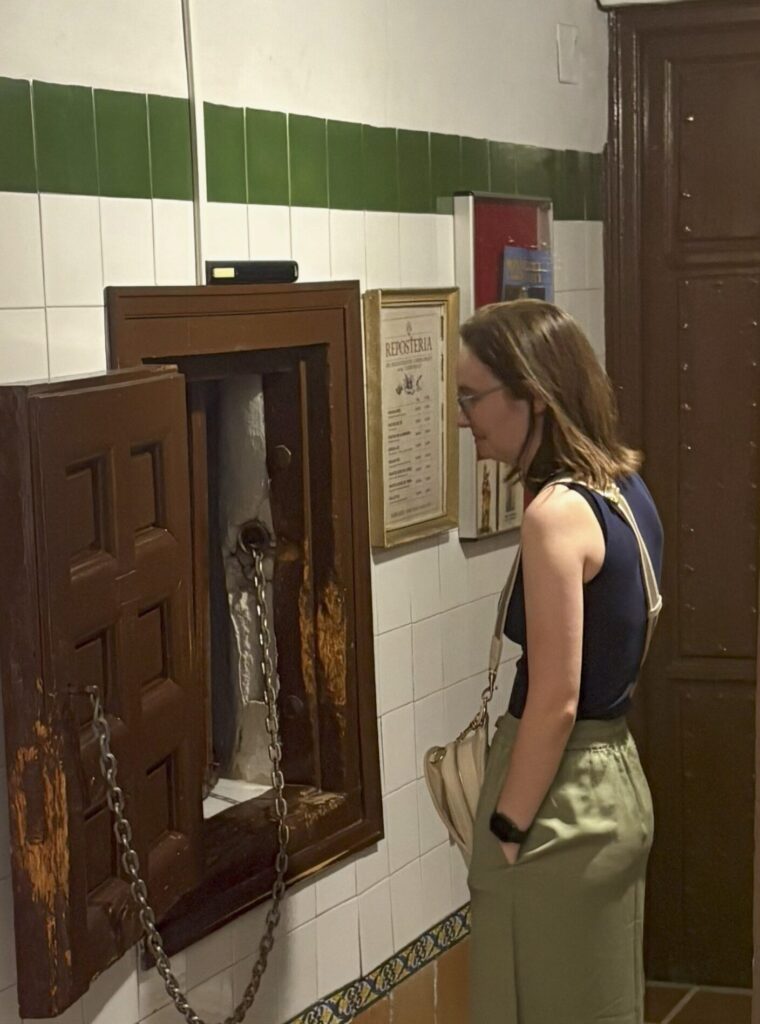 A woman stands in front of the turntable, about to recieve cookies