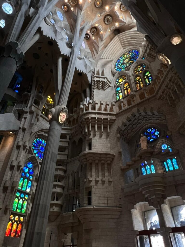 Stained glass windows and carvings on the interior of La Sagrada Familia