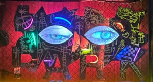 Graffiti with to real eyes in the middle.