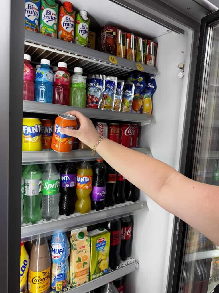 grabbing a fanta from the fridge.