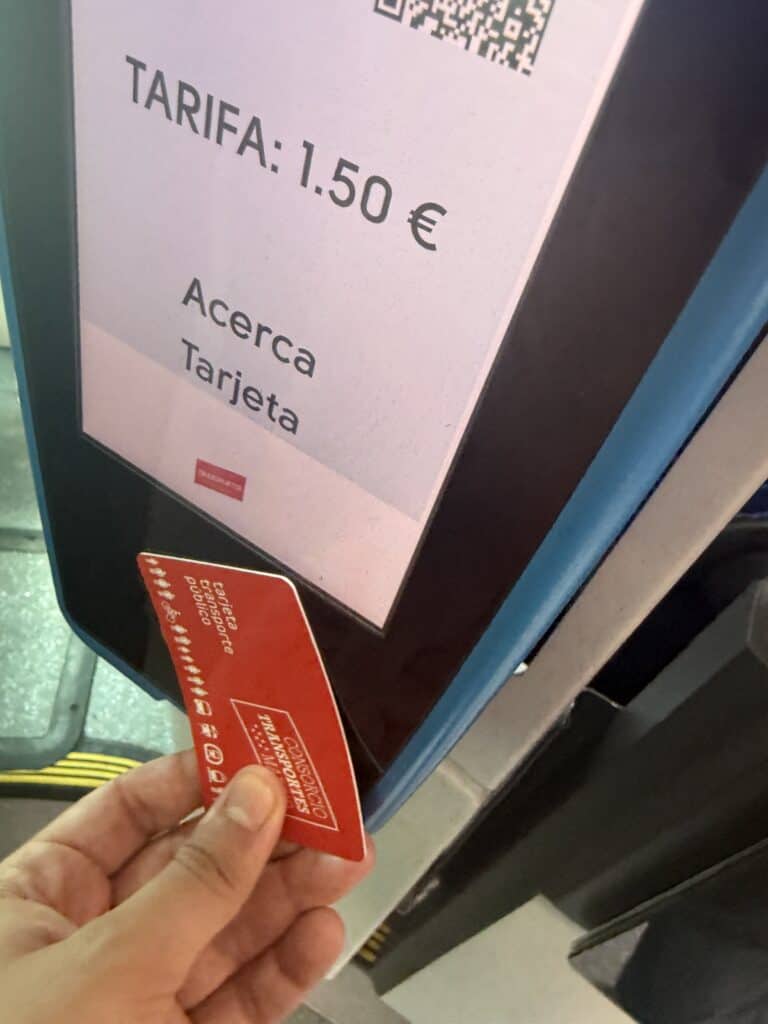 Using the transportation card to get on the bus.