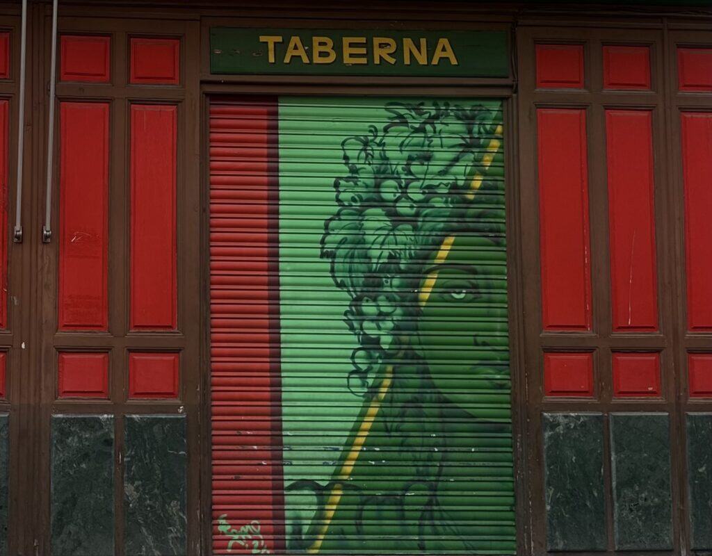 A woman painted in green, with Afro made out of leaves.