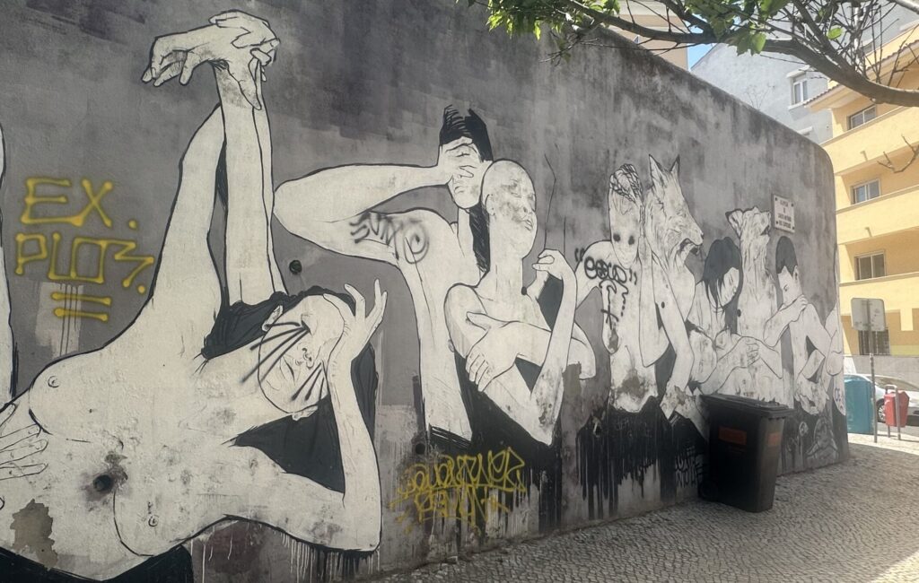 A mural of white bodies in distress but still showing love to one another by hugging.
