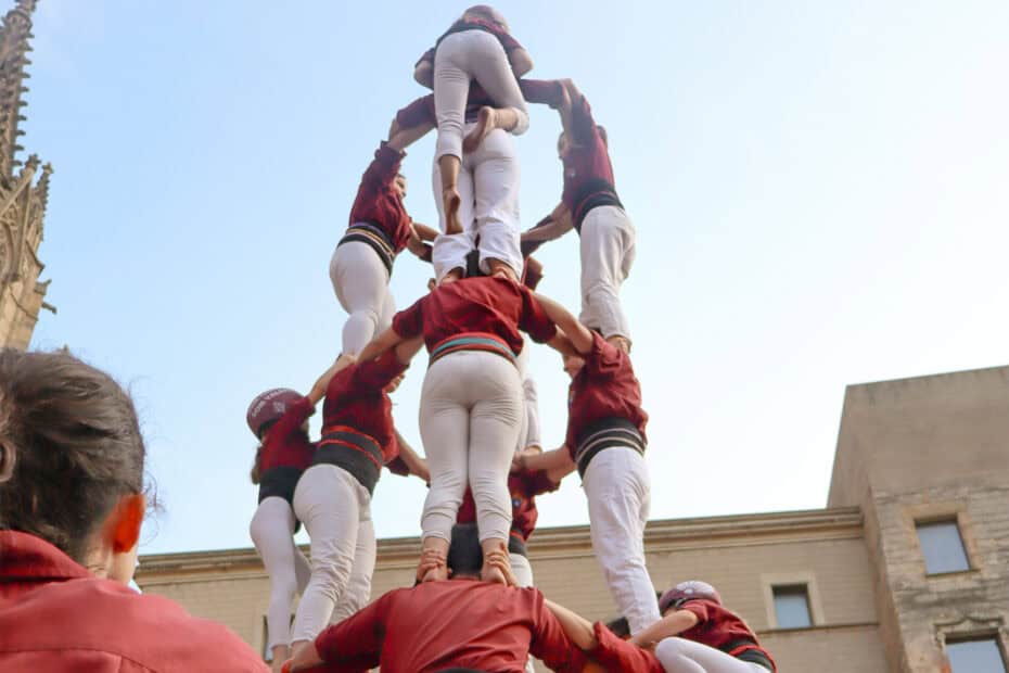 Castellers forming the base and mid section of a castell