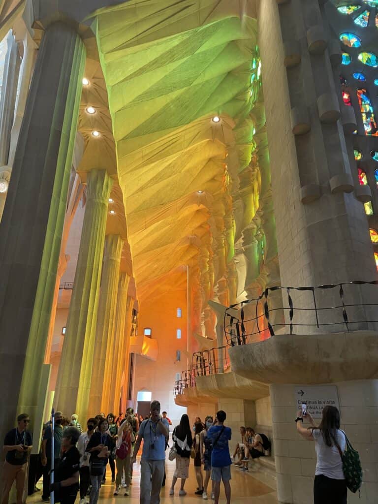 Orange, yellow and green light projected on the celling of the Sagrada Familia Basilica.